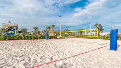 a volleyball court with a volleyball net on a sandy beach at 4749 Kings Castle in Kissimmee