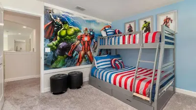a bedroom with a superhero mural on the wall at 4797 Kings Castle in Kissimmee