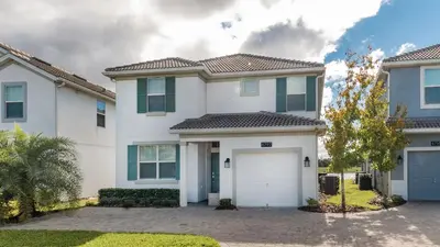 a large white house with a garage at 4797 Kings Castle in Kissimmee