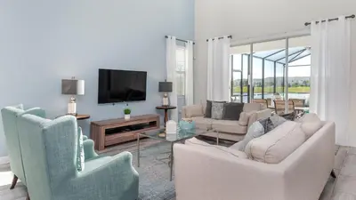 a living room with two chairs and a tv at 4797 Kings Castle in Kissimmee