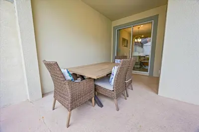 a wooden table with wicker chairs in a room at 4837 Lullaby in Kissimmee