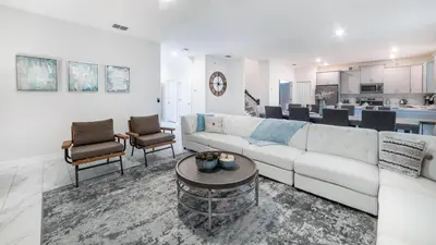 a living room with a white couch and a table at 4543 Narrative in Kissimmee