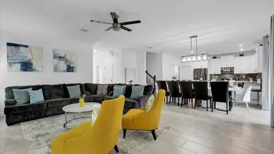 a living room with a couch and a table and chairs at 2718 Oxymoron in Kissimmee
