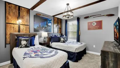 a bedroom with two beds and a tv in it at 2718 Oxymoron in Kissimmee