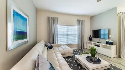 a living room with a white couch and a tv at 3141 Pequod in Kissimmee