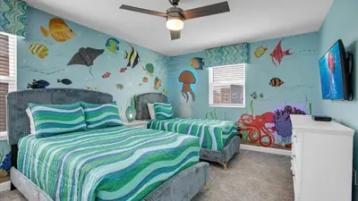 a bedroom with two beds and a fish mural at 4169 Paragraph in Kissimmee