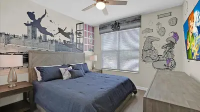 a bedroom with a bed with a blue comforter at 4277 Prologue in Kissimmee