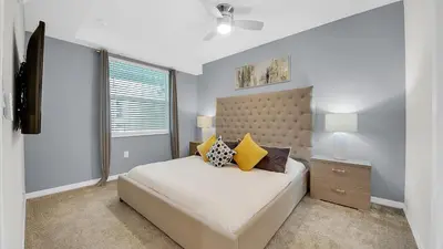 a bedroom with a large bed and a window at 3111 Paradox #202 in Kissimmee