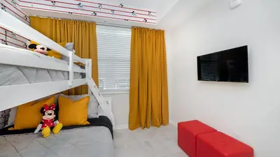 a bedroom with a bunk bed and a television at 3180 Paradox #303 in Kissimmee