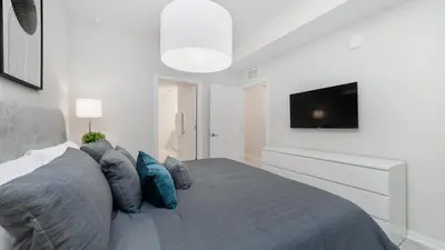 a bedroom with a bed with a tv on the wall at 3180 Paradox #303 in Kissimmee