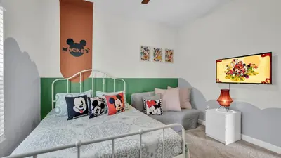a small bedroom with a bed and a couch at 4361 Quote in Kissimmee