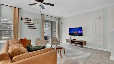 a living room with a couch and a tv at 4361 Quote in Kissimmee