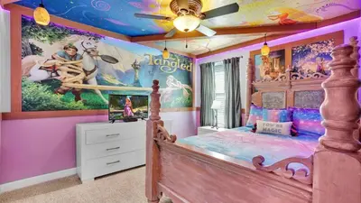 a childs bedroom with a disney mural on the wall at 4720 Sleepy Hollow in Kissimmee