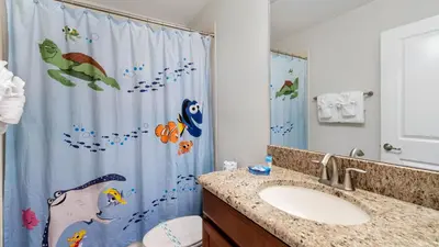 a bathroom with a shower curtain with birds on it at 4720 Sleepy Hollow in Kissimmee