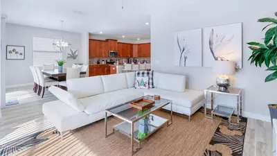 a living room with a white couch and a table at 4720 Sleepy Hollow in Kissimmee