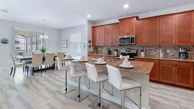 a kitchen and dining room with a table and chairs at 4720 Sleepy Hollow in Kissimmee