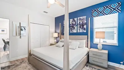a bedroom with a bed and a blue wall at 4724 Sleepy Hollow in Kissimmee