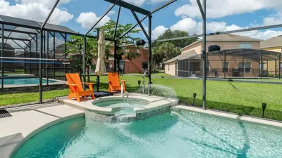 a swimming pool with two chairs and a fountain at 2787 Lido Key in Kissimmee