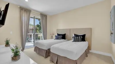 a bedroom with two beds and a large window at 7646 Recife in Kissimmee