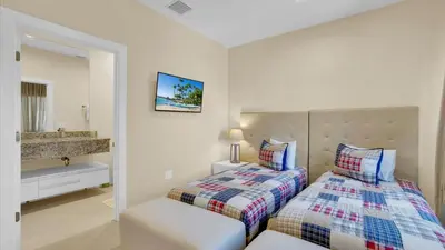 a bedroom with two beds and a sink at 7646 Recife in Kissimmee