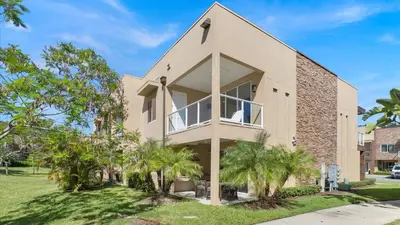 a house with a large window and palm trees at 7646 Recife in Kissimmee