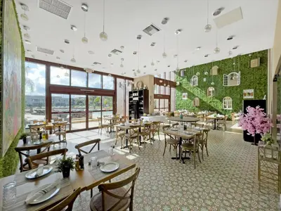 a restaurant with tables and chairs in a room at 7646 Recife in Kissimmee
