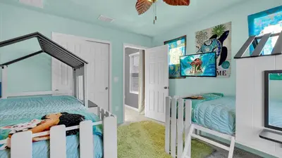 a bedroom with two twin beds and a tv at 2147 Cooper Bell in Kissimmee