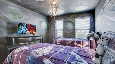 a bedroom with a bed with a spider man bedspread at 2147 Cooper Bell in Kissimmee