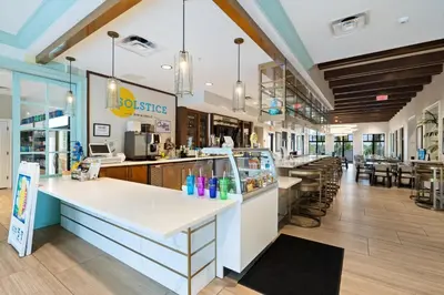 a restaurant with a counter and tables and chairs at 2147 Cooper Bell in Kissimmee
