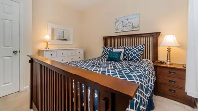 a bedroom with a bed with a blue and white comforter at 7650 Comrow #204 in Kissimmee