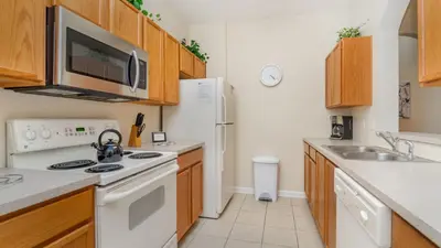a kitchen with a sink and a refrigerator at 7650 Comrow #204 in Kissimmee