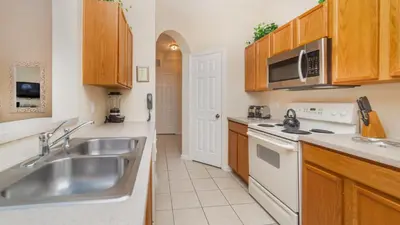 a kitchen with a sink and a stove at 7650 Comrow #204 in Kissimmee