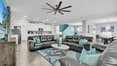 a living room with leather couches and a kitchen at 1840 Caribbean View in Kissimmee