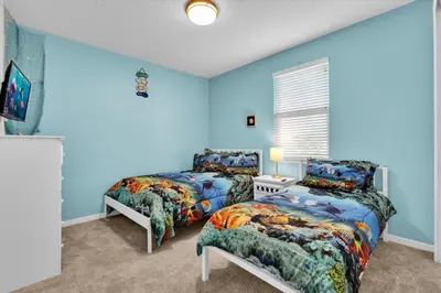 two beds in a room with blue walls at 1840 Caribbean View in Kissimmee