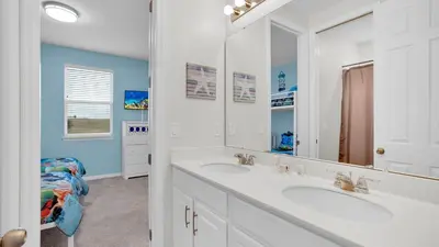 a bathroom with two sinks and a large mirror at 1840 Caribbean View in Kissimmee