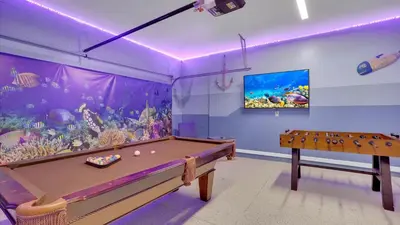 a room with a pool table and an aquarium at 1840 Caribbean View in Kissimmee