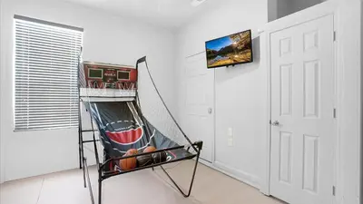 a room with a hammock and a tv on a wall at 7705 Comrow in Kissimmee