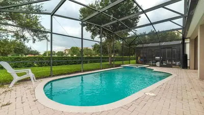 a swimming pool in a house with a glass house at 7705 Comrow in Kissimmee