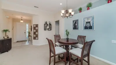 a dining room with a table and chairs at 7705 Comrow in Kissimmee
