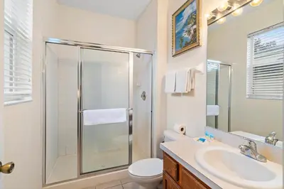 a bathroom with a shower and a toilet and a sink at 7719 Comrow in Kissimmee