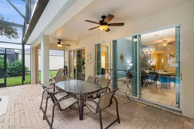 a dining room with a ceiling fan and a table at 7719 Comrow in Kissimmee