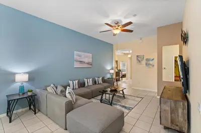 a living room with a couch and a ceiling fan at 7719 Comrow in Kissimmee