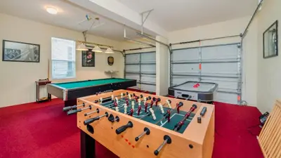 a room with a pool table and ping pong ball at 7730 Comrow in Kissimmee