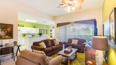 a living room with two couches and a table at 2633 Daulby in Kissimmee
