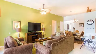 a living room with couches and a flat screen tv at 2633 Daulby in Kissimmee