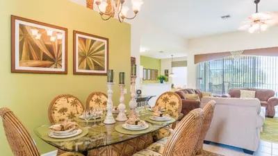 a dining room with a glass table and chairs at 2633 Daulby in Kissimmee
