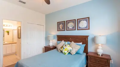 a bedroom with a blue bed with blue sheets and pillows at 2633 Daulby in Kissimmee