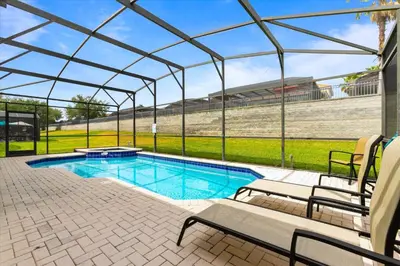 a swimming pool in a tent with two chairs and a swimming pool at 2678 Manesty in Kissimmee