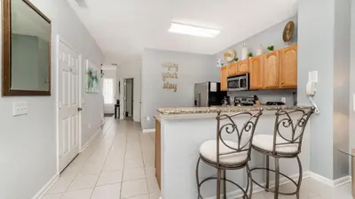 a kitchen with a counter and two stools at 2537 Maneshaw in Kissimmee