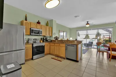 a kitchen with wooden cabinets and stainless steel appliances at 2549 Maneshaw in Kissimmee